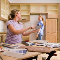 sisters choosing paint colors for kitchen - home decoration stock pictures, royalty-free photos & images