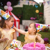 sisters having fun on a birthday party - home decoration stock pictures, royalty-free photos & images