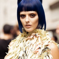 Sita Abellan with blue hair wears light pink yellow and green colour dress outside Marni during the Milan Fashion Week Spring/Summer 2025 on...