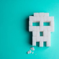 skull made of sugar cubes with a broken tooth. concept of tooth decay. - junk food stock pictures, royalty-free photos & images