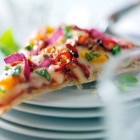 slice of pizza on stack of plates - junk food stockfoto's en -beelden