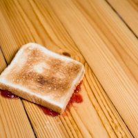 slice of toast with strawberry jam turned upside down on floor - food stock pictures, royalty-free photos & images