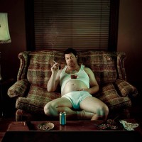 slob man watching television while smoking in underwear - junk food stock pictures, royalty-free photos & images
