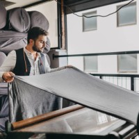 small business owner checking the fabric for the last time - fashion stock pictures, royalty-free photos & images
