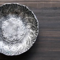 small textured metal plate on a wooden background - garden decoration stock pictures, royalty-free photos & images