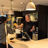 smiles and service at the pastry counter - junk food stock pictures, royalty-free photos & images