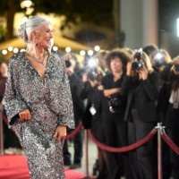 smiling actress in shiny gown posing at event - fashion stock pictures, royalty-free photos & images