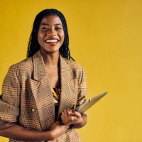 smiling african american businesswoman in a plaid blazer holding a tablet in a modern office. empowerment and professional growth in business concept - home decoration stock-fotos und bilder