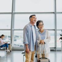 smiling asian senior couple tourists in airport - travel stock pictures, royalty-free photos & images
