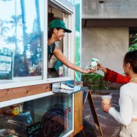 smiling barista hands coffee to customer - junk food stock pictures, royalty-free photos & images