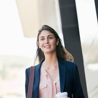 smiling businesswoman walking with coffee cup - junk food stock pictures, royalty-free photos & images