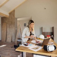 smiling female architect working on laptop at construction site. - home decoration stock pictures, royalty-free photos & images