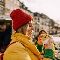 smiling friends trying out local street food - food stock pictures, royalty-free photos & images