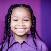 smiling girl (8-9) with plaits, portrait, close-up - hairstyle photos et images de collection