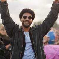 smiling man dancing with arms raised by woman - concert stock pictures, royalty-free photos & images