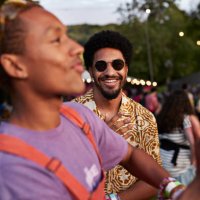 smiling man looking at friend dancing carefree - concert stock pictures, royalty-free photos & images