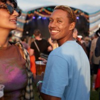 smiling man with woman enjoying music festival - concert stock pictures, royalty-free photos & images