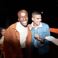smiling men enjoying with friends at night - fashion stock pictures, royalty-free photos & images