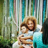 smiling mother embracing toddler daughter - garden decoration stock pictures, royalty-free photos & images