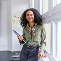 smiling portrait of a beautiful woman standing in office - fashion stock pictures, royalty-free photos & images