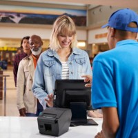 smiling woman buying tickets at counter in theater - junk food stock pictures, royalty-free photos & images