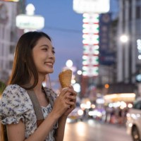 smiling woman holding ice cream on street food in thailand in summer. - junk food stock pictures, royalty-free photos & images