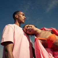 smiling woman leaning on man against sky - fashion stock pictures, royalty-free photos & images