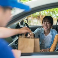smiling woman taking orders on the side of the road - junk food stock pictures, royalty-free photos & images