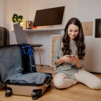 smiling woman using mobile phone - travel stock pictures, royalty-free photos & images