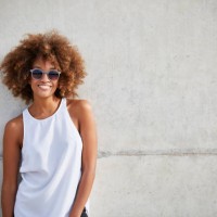 smiling woman wearing tank top and sunglasses - fashion stock pictures, royalty-free photos & images