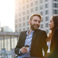 smiling young businesswoman and businessman outdoors - junk food stock pictures, royalty-free photos & images