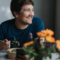 smiling young man eating meal at table - food stock pictures, royalty-free photos & images