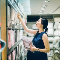 smiling young pregnant woman shopping for home necessities in shop - home decoration stock pictures, royalty-free photos & images