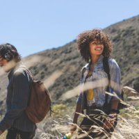 smiling young woman hiking with boyfriend on sunny day - travel stock pictures, royalty-free photos & images