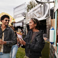 smiling young woman holding dessert by friend - junk food stock pictures, royalty-free photos & images