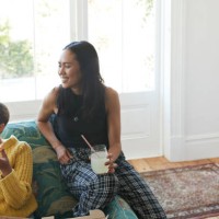 smiling young women with fresh pizza and drink - junk food stock pictures, royalty-free photos & images