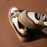 sneakers in brown tones on a brown background. stylish women's shoes. keds. part of a fashionable image. - fashion photos et images de collection