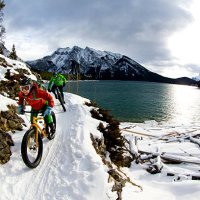 snow biking couple - travel stock pictures, royalty-free photos & images