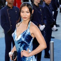 Snowboarder Chloe Kim poses during a photocall upon arrival to attend the Spring/Summer 2025 menswear ready to wear joint fashion show hosted by...