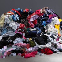 sofa buried under piles of clothes - fashion stock pictures, royalty-free photos & images