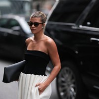 Sofia Richie is seen outside Proenza Schouler show wearing brown Saint Laurent sunnies, Tiffany blue circle earrings, black shoulder free top, white...