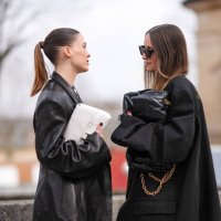 Sofia Roe wears a white Balenciaga bag, a black leather blazer jacket, Charlotte Groeneveld wears a black oversized blazer jacket as a dress, a black...
