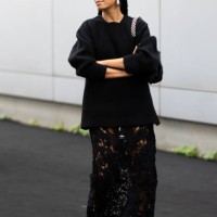 Solange Knowles is seen wearing hoop silver earrings, black fur sandals embroidered with rhinestones, a black long sweater, a black long lace skirt...