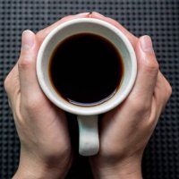 someone hands holding a mug of black coffee before drinking. - coffee stock pictures, royalty-free photos & images