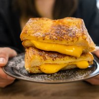someone holding a cheese toast before eating. - junk food stock pictures, royalty-free photos & images