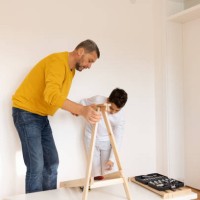 son assembling furniture with father - home decoration stock pictures, royalty-free photos & images