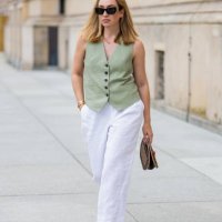 Sonia Lyson wears pink black Chanel ballerinas, white linen pants & green vest Zara, Louis Vuitton bag, sunglasses Miu Miu during the Berlin Fashion...