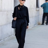 Sophia Roe wears navy wide leg pants, shirt, bag outside Cos during New York Fashion Week on September 10, 2024 in New York City.
