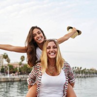 spain, barcelona, young woman giving her friend a piggyback ride - fashion stock pictures, royalty-free photos & images