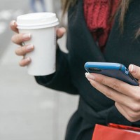spain, young woman with smartphone and coffee to go, close-up - junk food stock pictures, royalty-free photos & images